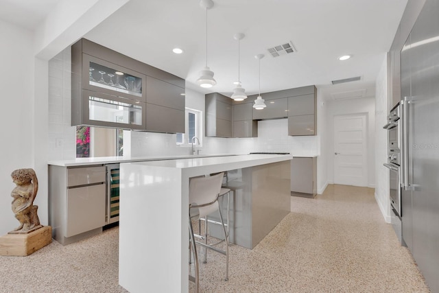 2525 Venetian Way, Winter Park, FL 32789 - kitchen with visible vents, modern cabinets, gray cabinetry, and a kitchen breakfast bar