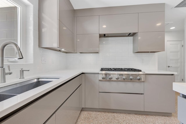 2525 Venetian Way, Winter Park, FL 32789 - kitchen with visible vents, decorative backsplash, stainless steel gas cooktop, light countertops, and a sink