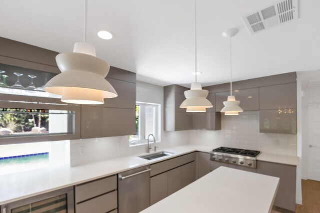 2525 Venetian Way, Winter Park, FL 32789 - kitchen featuring visible vents, modern cabinets, tasteful backsplash, a sink, and appliances with stainless steel finishes