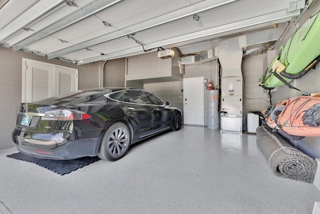 2525 Venetian Way, Winter Park, FL 32789 - garage with water heater, concrete block wall, heating unit, and a garage door opener