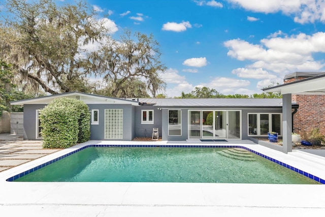 2525 Venetian Way, Winter Park, FL 32789 - back of property with a patio area, metal roof, and an outdoor pool