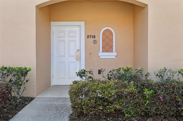 entrance to property with stucco siding