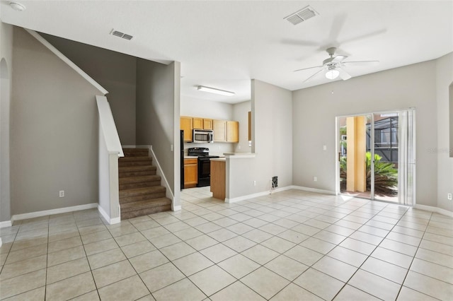 unfurnished living room featuring ceiling fan, stairs, light tile patterned flooring, and visible vents