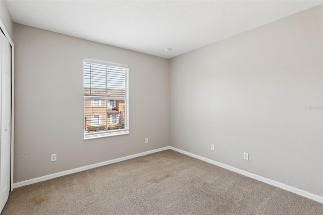 spare room with carpet floors and baseboards