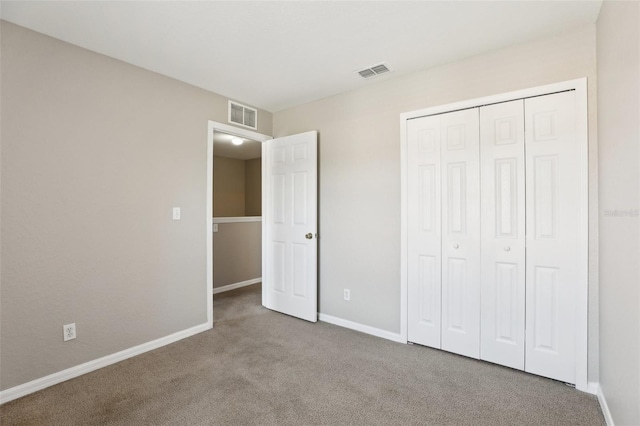 unfurnished bedroom featuring carpet floors, baseboards, and visible vents