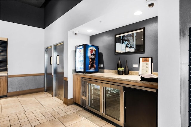 bar featuring recessed lighting, a dry bar, and light tile patterned flooring