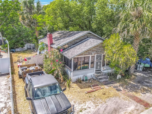 1314 S Mellonville Ave, Sanford, FL 32771 - exterior space featuring a shingled roof, a sunroom, and fence