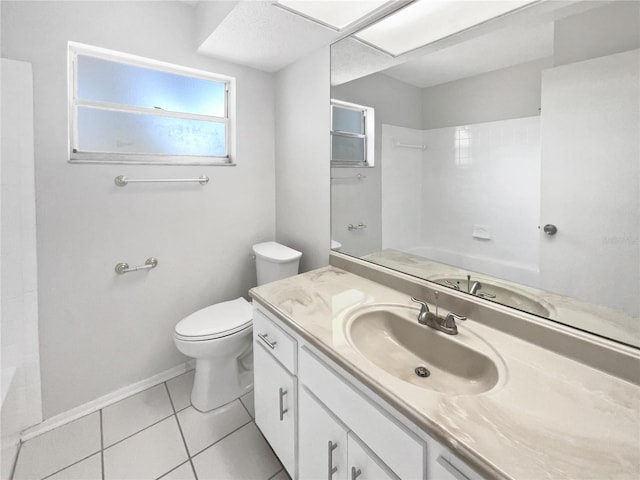 full bathroom with vanity, toilet, tile patterned floors, baseboards, and shower / washtub combination