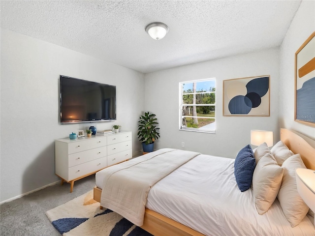 bedroom with a textured ceiling, light carpet, and baseboards
