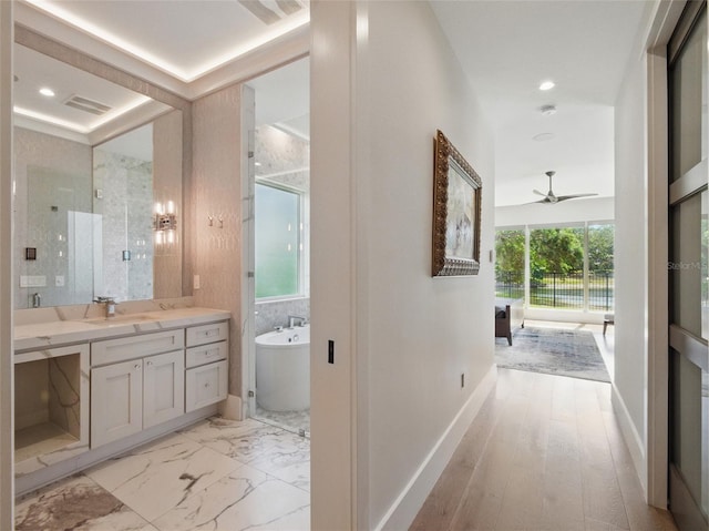 full bath with ceiling fan, vanity, a freestanding tub, visible vents, and a stall shower