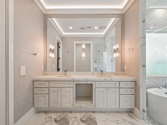 full bathroom featuring a sink, a freestanding tub, double vanity, and marble finish floor
