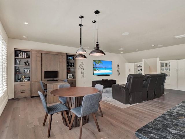 dining room with recessed lighting, light wood-style flooring, and lofted ceiling