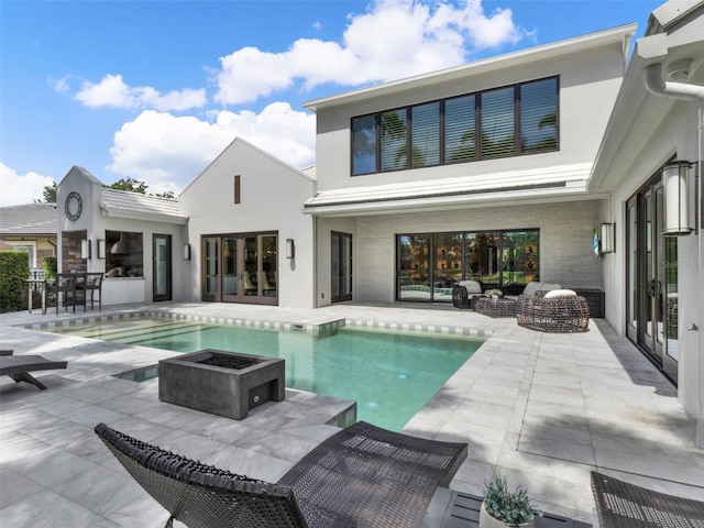 back of house featuring french doors, an outdoor pool, a patio area, and stucco siding