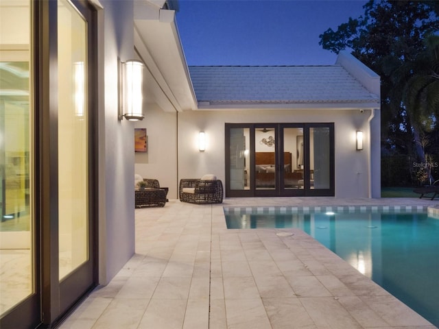 back of house with an outdoor pool, a patio area, an exterior structure, an outdoor structure, and stucco siding