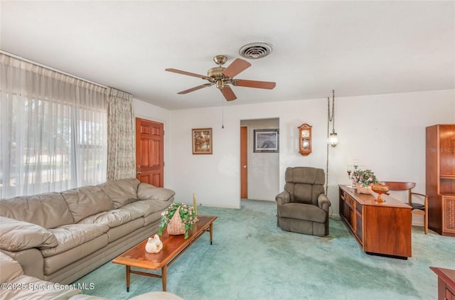 carpeted living area with a ceiling fan and visible vents