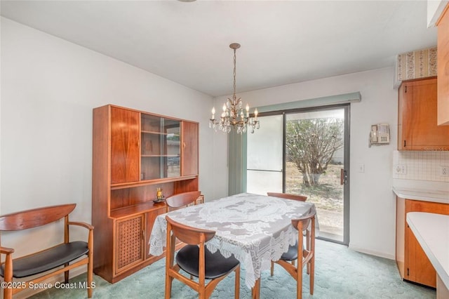 dining room featuring an inviting chandelier and light carpet
