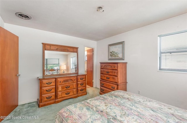 bedroom featuring carpet floors and visible vents