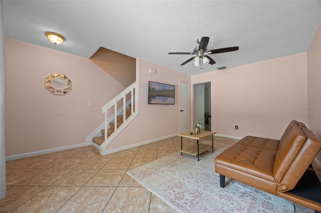 130 Kristi Ann Ct, Winter Springs, FL 32708 - living area with stairs, a ceiling fan, a textured ceiling, and tile patterned floors
