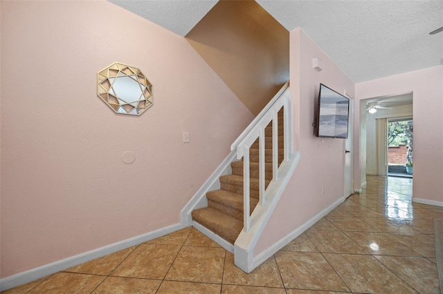 130 Kristi Ann Ct, Winter Springs, FL 32708 - stairs featuring ceiling fan, baseboards, tile patterned flooring, and a textured ceiling