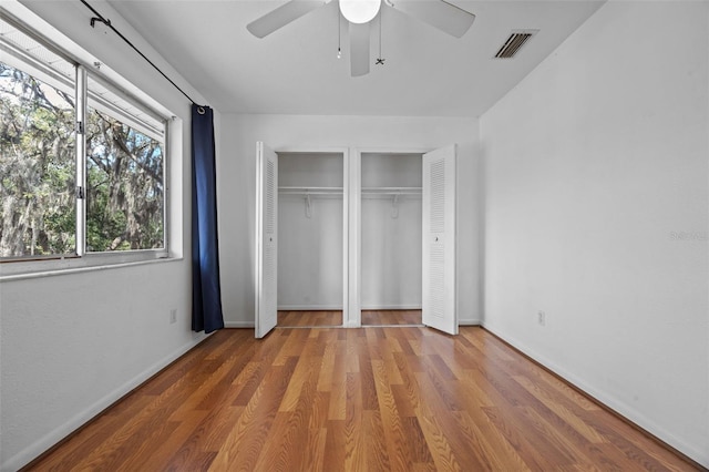 130 Kristi Ann Ct, Winter Springs, FL 32708 - unfurnished bedroom with visible vents, baseboards, two closets, and wood finished floors