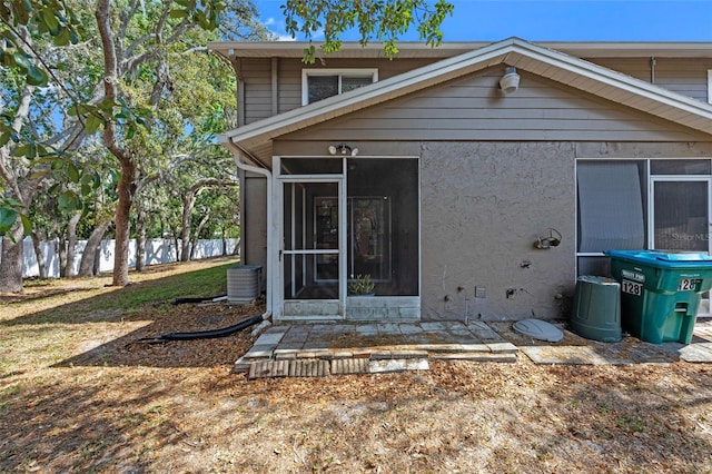 130 Kristi Ann Ct, Winter Springs, FL 32708 - back of house with fence, central AC unit, stucco siding, and a sunroom