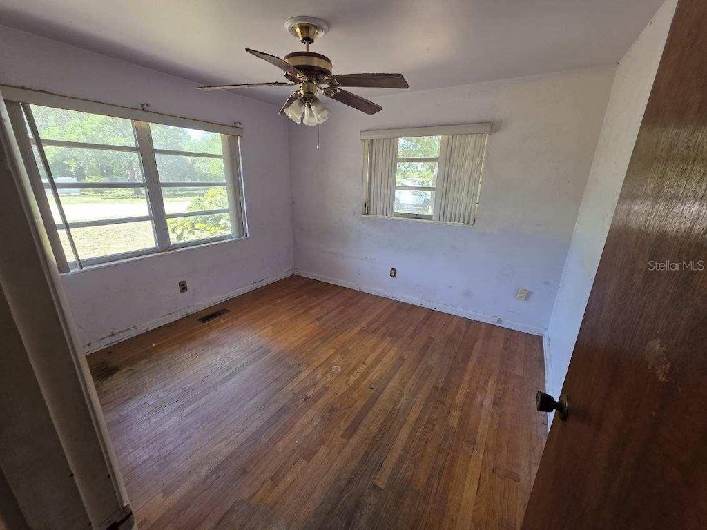 2523 Falkner Rd, Orlando, FL 32810 - unfurnished room with a ceiling fan, wood finished floors, and visible vents
