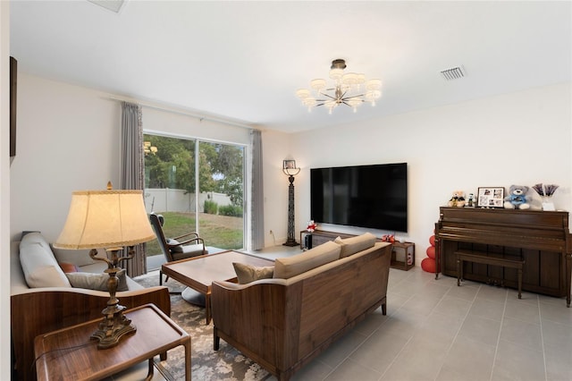 living room featuring an inviting chandelier, light tile patterned floors, and visible vents