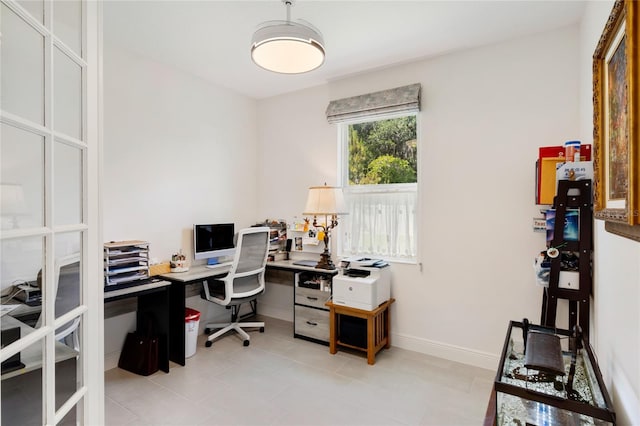 office with light tile patterned floors and baseboards