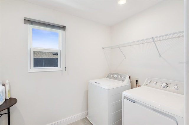 laundry area featuring laundry area, washing machine and dryer, and baseboards