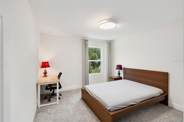 carpeted bedroom featuring baseboards