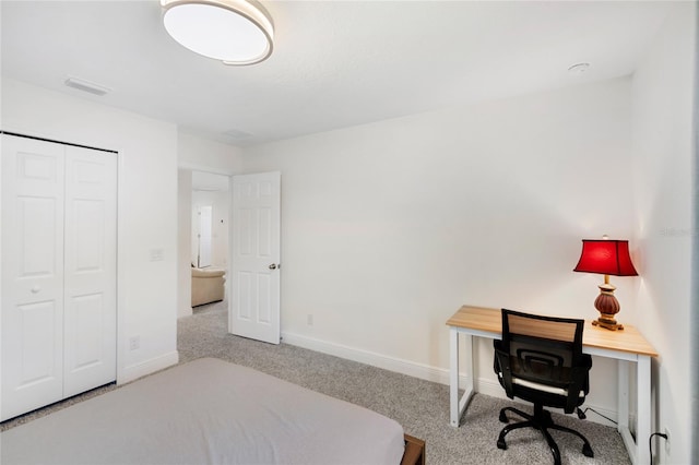 carpeted bedroom with baseboards, visible vents, and a closet