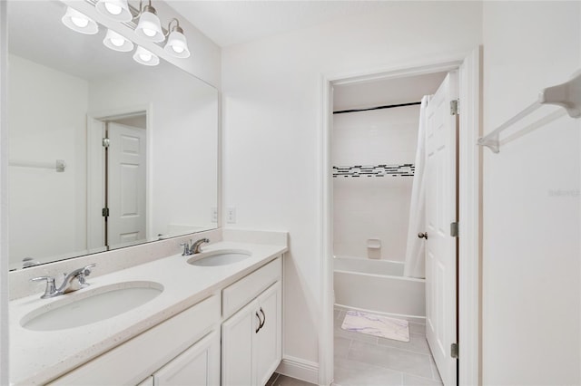 bathroom with double vanity, a sink, shower / bathing tub combination, and baseboards