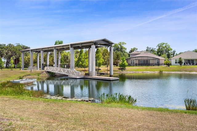 view of dock featuring a lawn and a water view