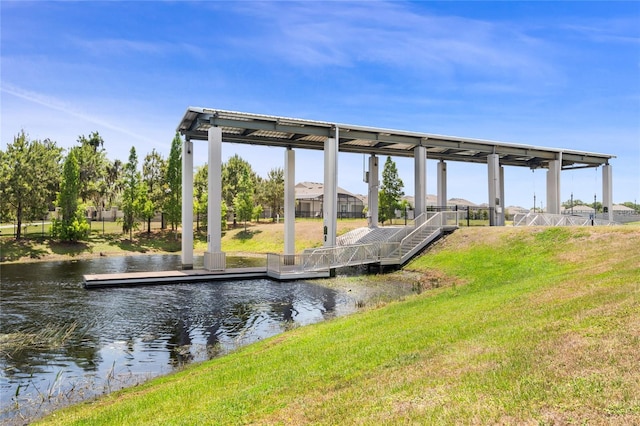 dock area featuring a lawn and a water view