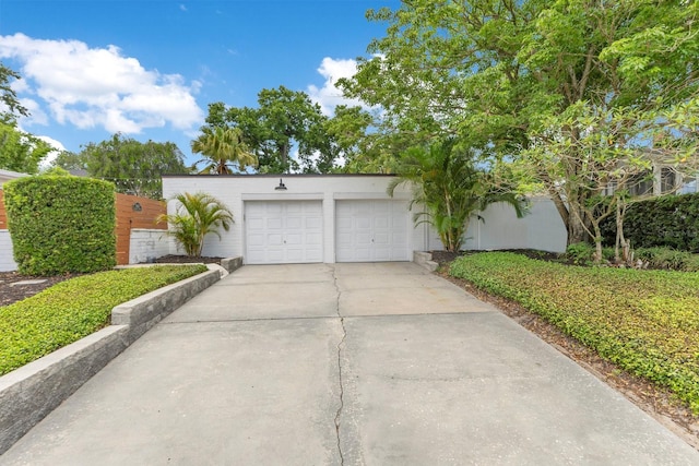garage with concrete driveway