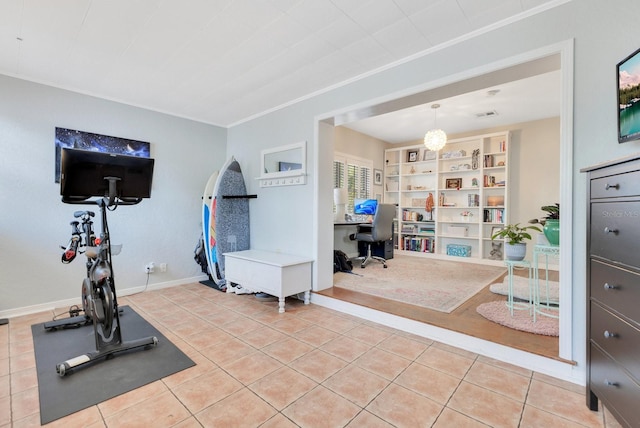 workout room with crown molding, tile patterned floors, built in features, and baseboards