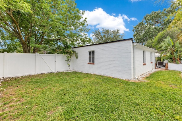 exterior space featuring a gate and a fenced backyard