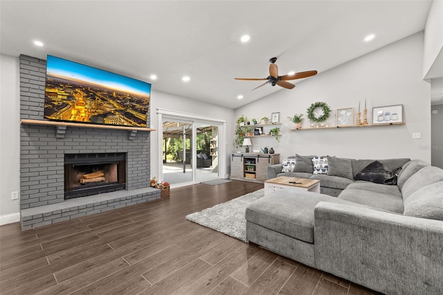 living area with wood finished floors, a fireplace, ceiling fan, recessed lighting, and vaulted ceiling