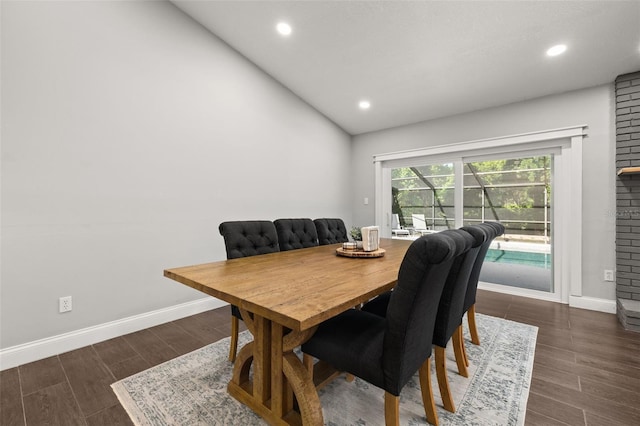 dining space with baseboards, recessed lighting, wood finished floors, and vaulted ceiling