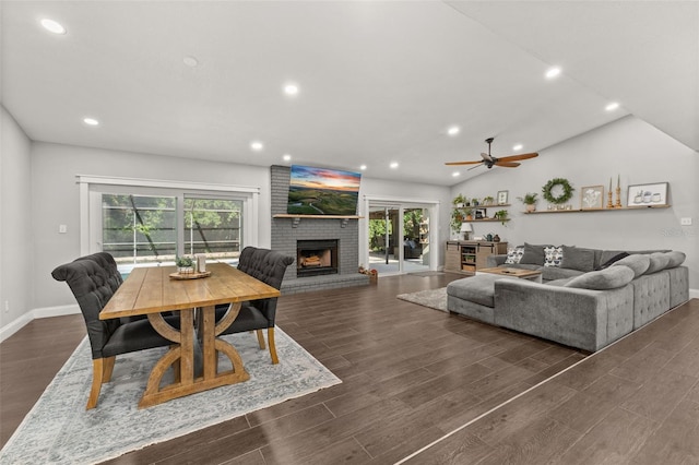 living area with a brick fireplace, recessed lighting, baseboards, and a wealth of natural light
