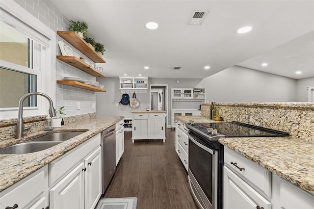 kitchen with white cabinets, stainless steel appliances, open shelves, and a sink