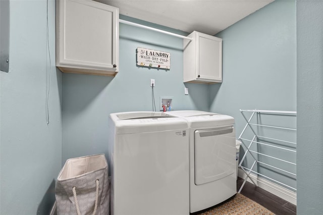clothes washing area featuring separate washer and dryer, cabinet space, and dark wood-type flooring