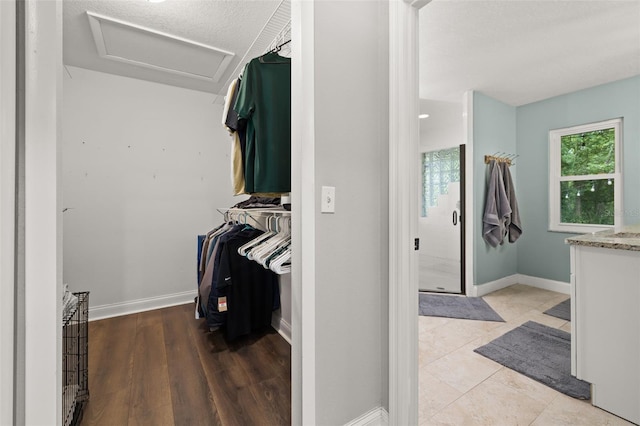 walk in closet featuring attic access