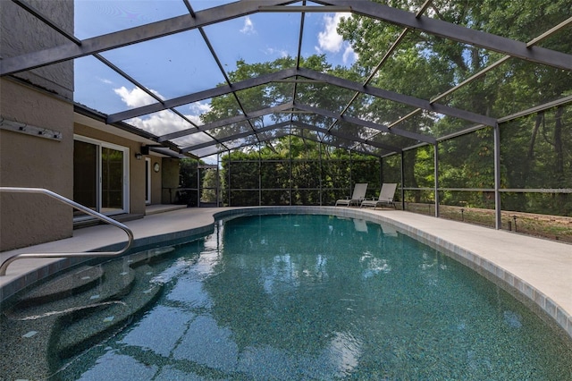 pool with a lanai and a patio area