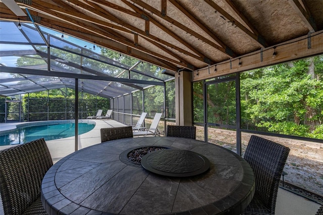 sunroom featuring outdoor dining area