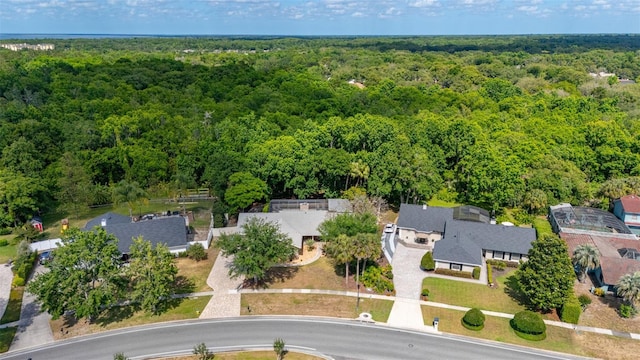 birds eye view of property with a wooded view