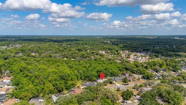 birds eye view of property featuring a residential view and a wooded view
