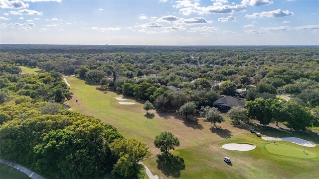 aerial view with a wooded view and golf course view