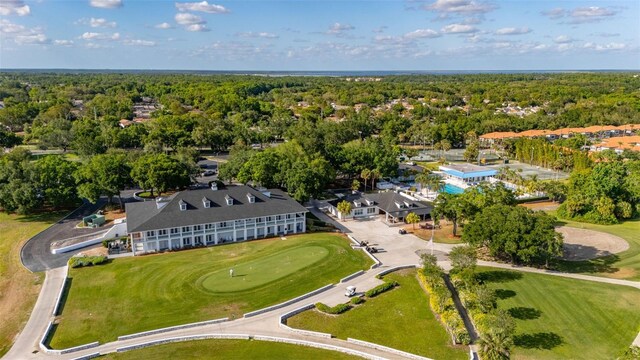 drone / aerial view with a view of trees and view of golf course