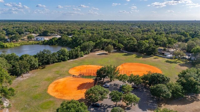 drone / aerial view featuring a water view, a view of trees, and golf course view